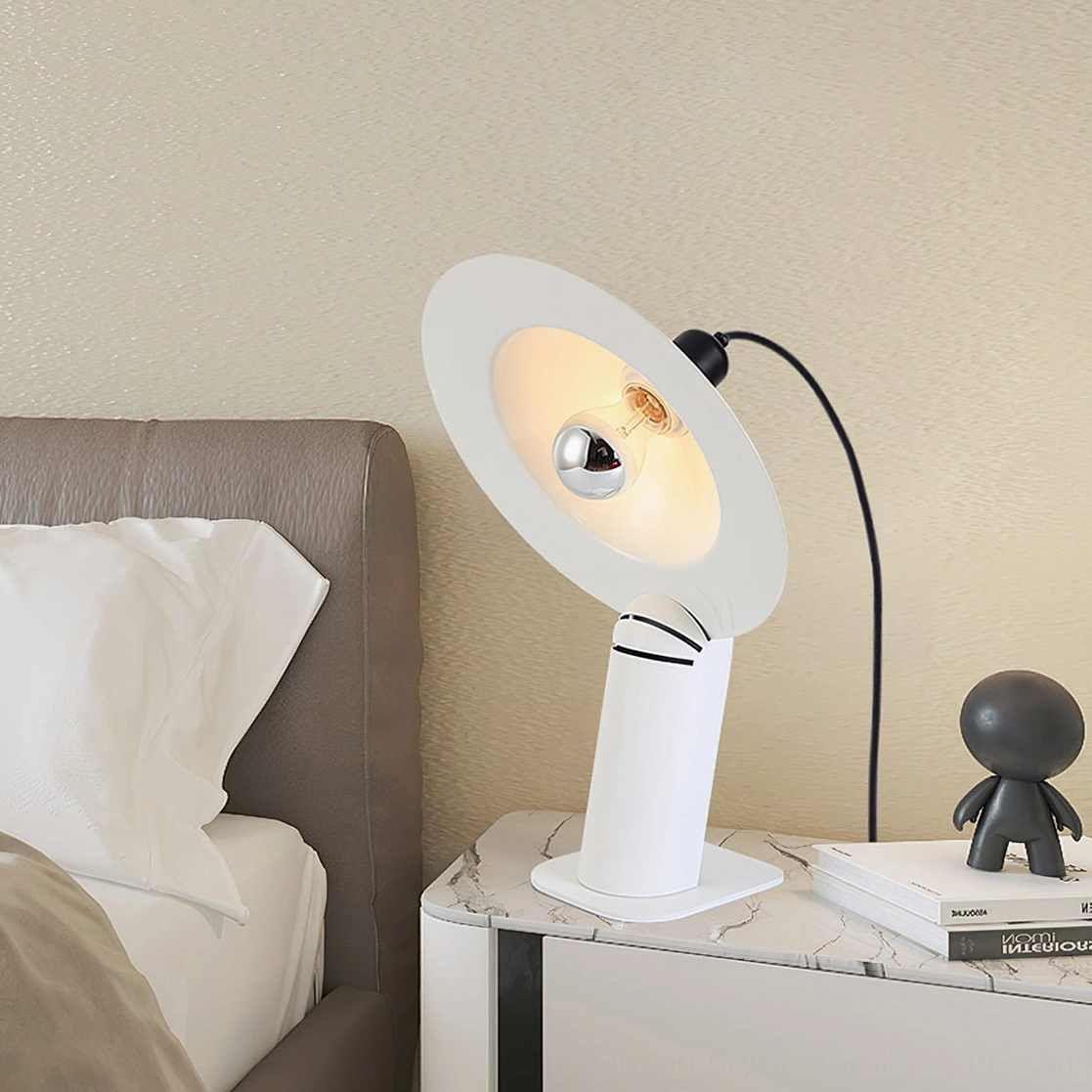 Lampiatta disc table lamp in sophisticated matte black finish with contemporary sculptural design and light adjustment capability