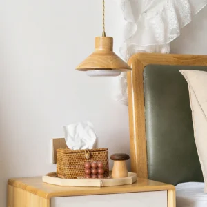Lander pendant light installed above wooden nightstand in modern bedroom with sheer lace curtain