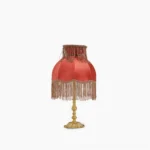 Lanna tassel table lamp front view with burgundy red fabric shade and hand-sewn tassel trim, brass base, studio white background