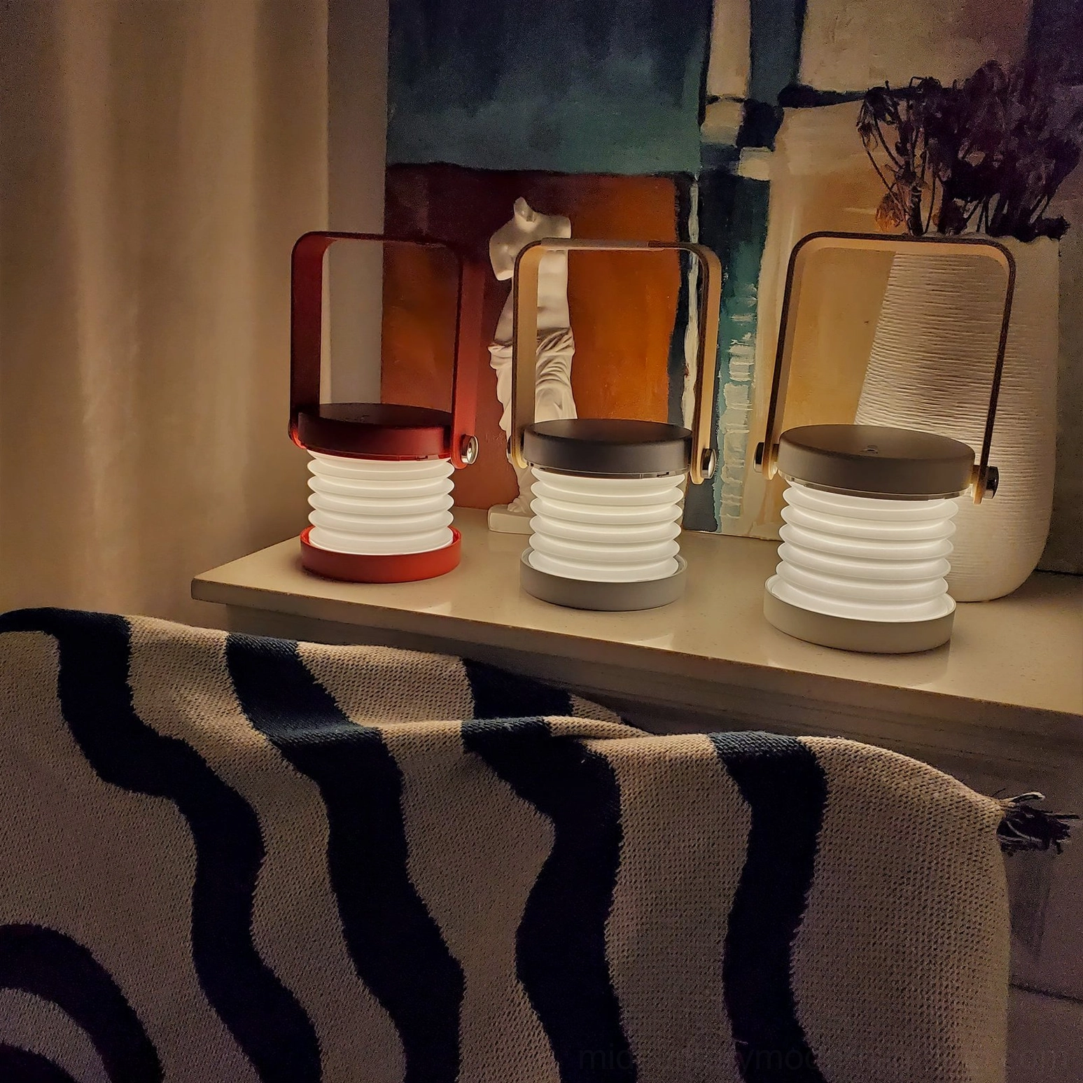 Lantern table lamp creating warm architectural light pattern, Scandinavian minimalist design on contemporary desk