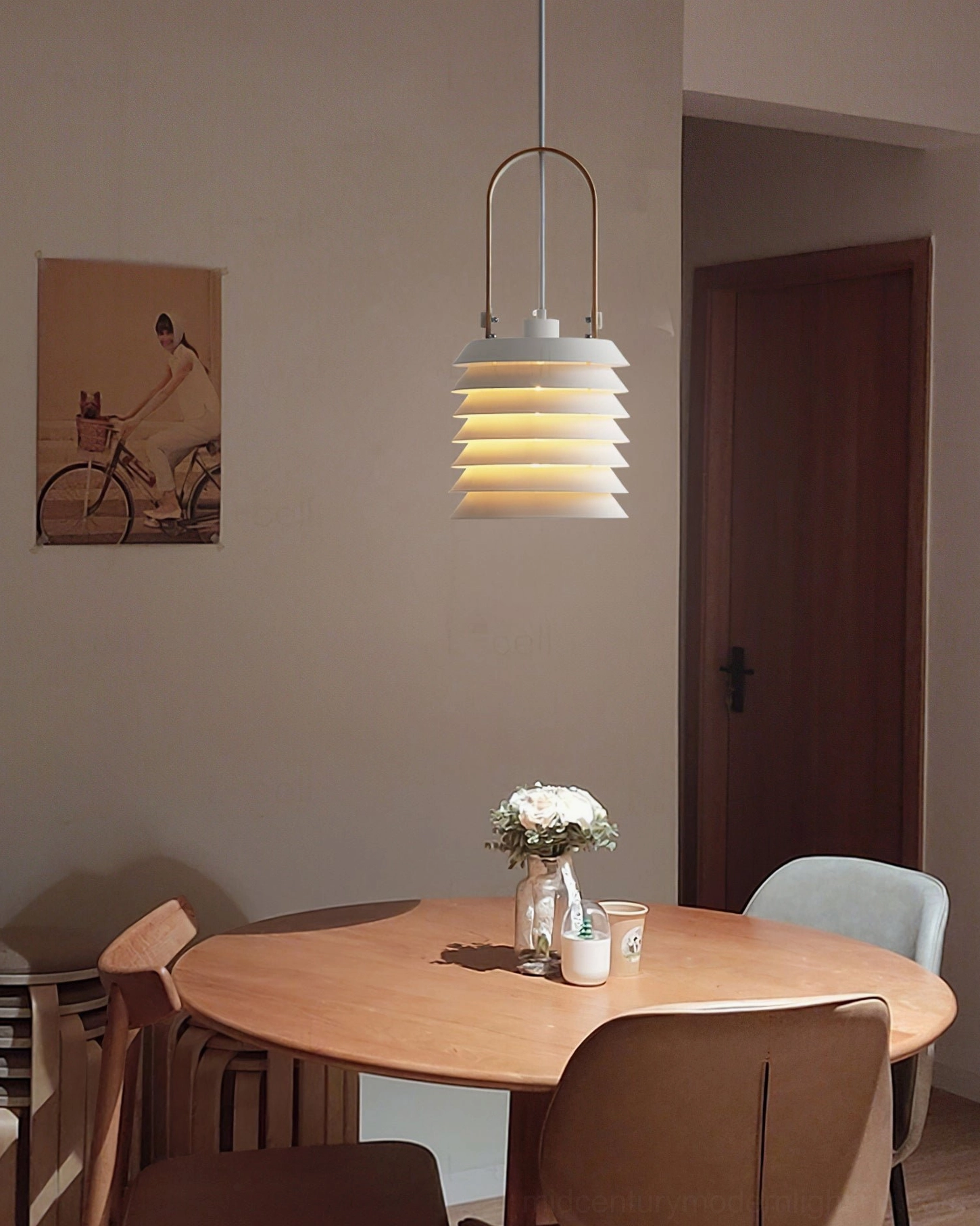 Single honeycomb lantern pendant above round dining table with flowers and warm wooden furniture