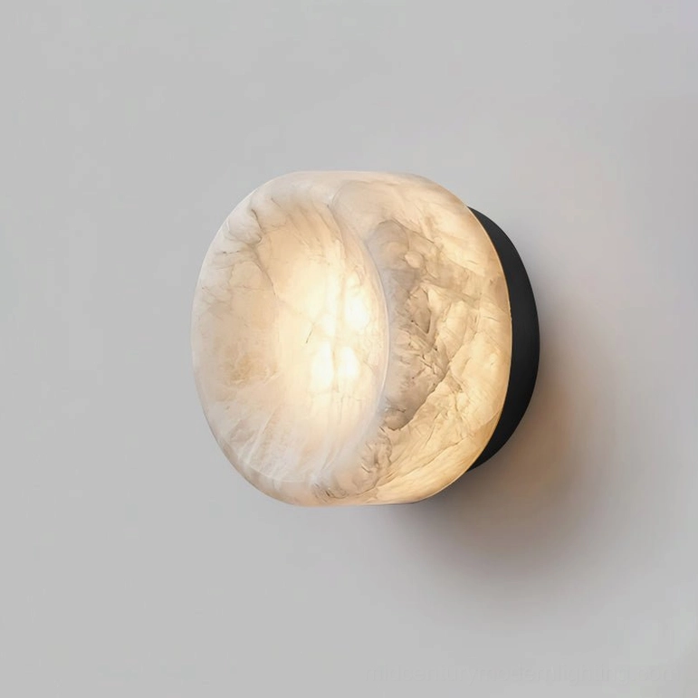 Large size alabaster wall sconce with black brushed metal base mounted on hallway wall with neutral decor