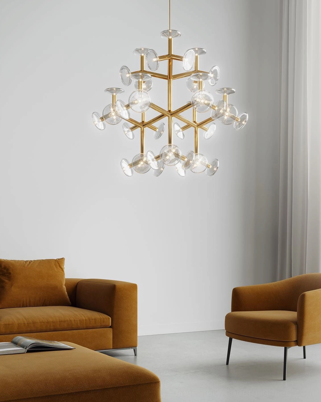 Large gold branch chandelier suspended in contemporary living room with tan brown sofa
