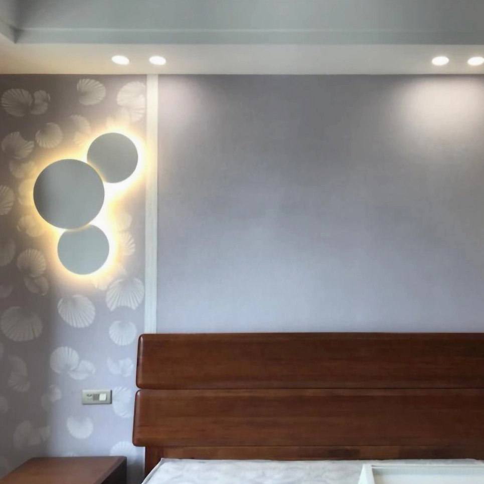 Large-scale geometric disc wall sconce in contemporary space demonstrating architectural focal point lighting statement