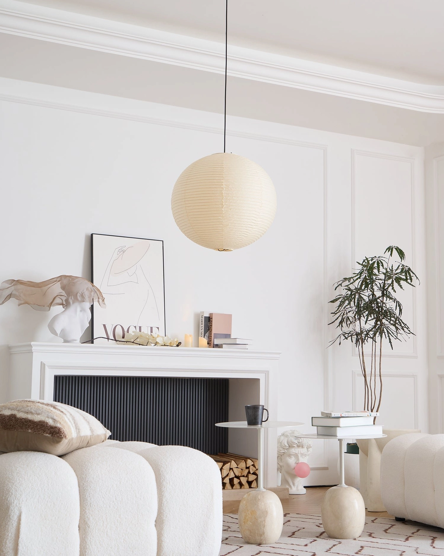 Large washi paper pendant lamp creating ambient lighting in dining space