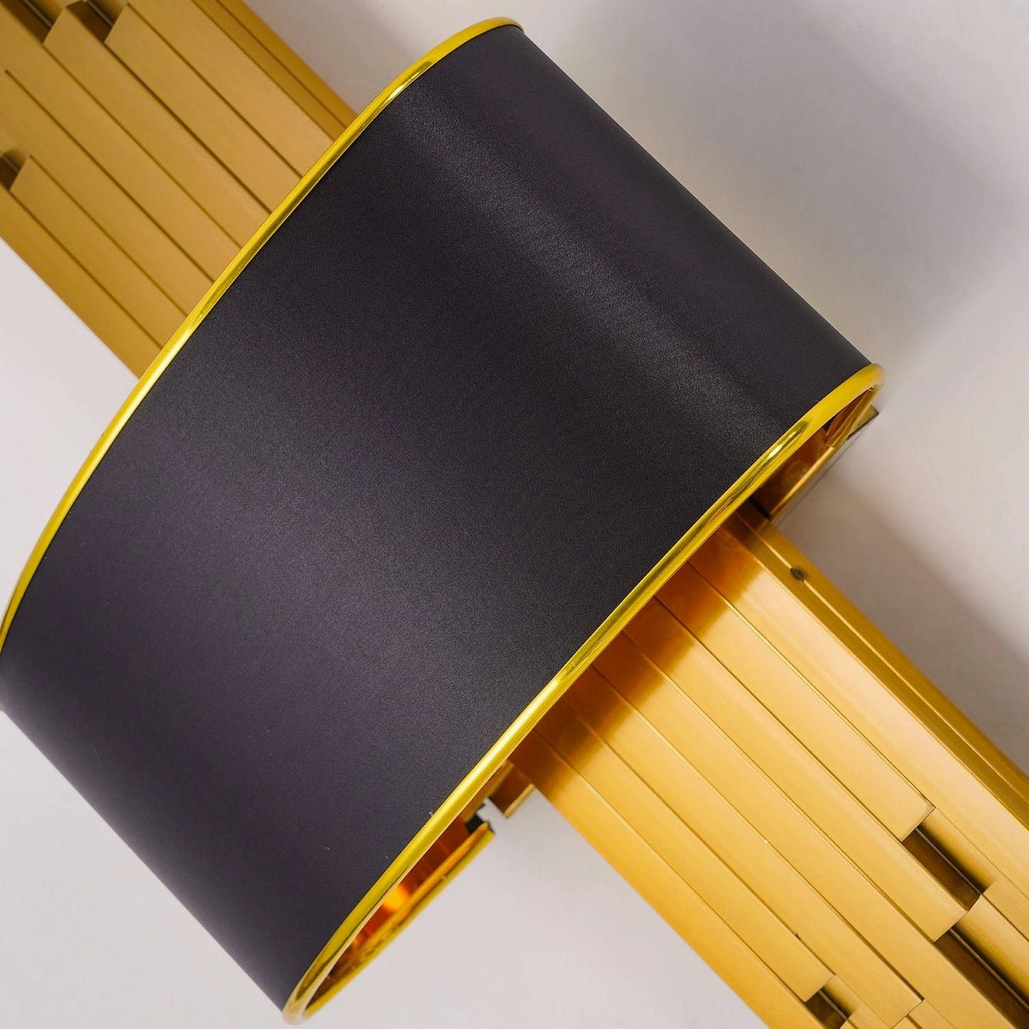 Laurina wall lamp gold metal base and black fabric shade connection detail, contemporary design