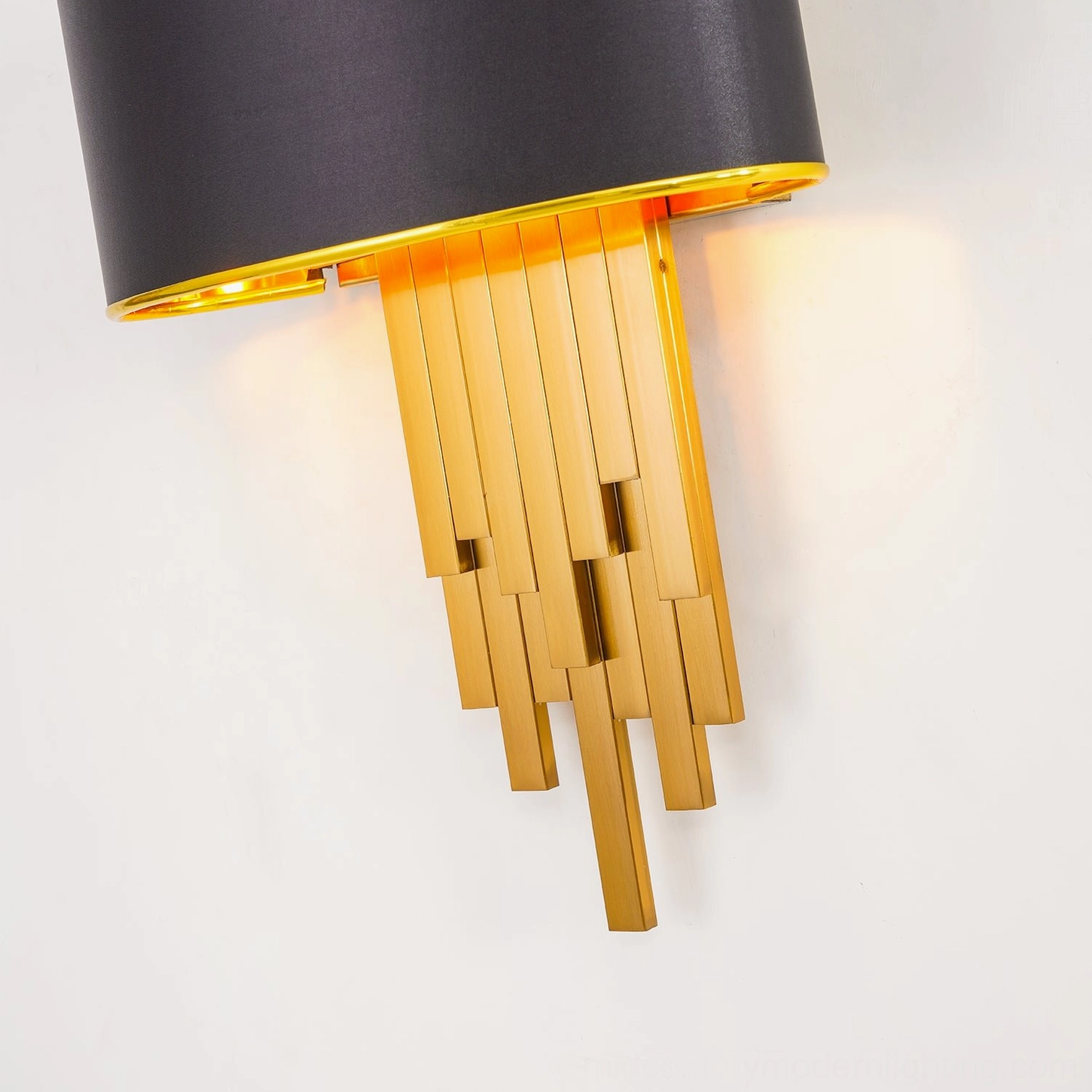 Close-up detail of Laurina wall sconce showing brushed gold tube connection and black fabric shade edge