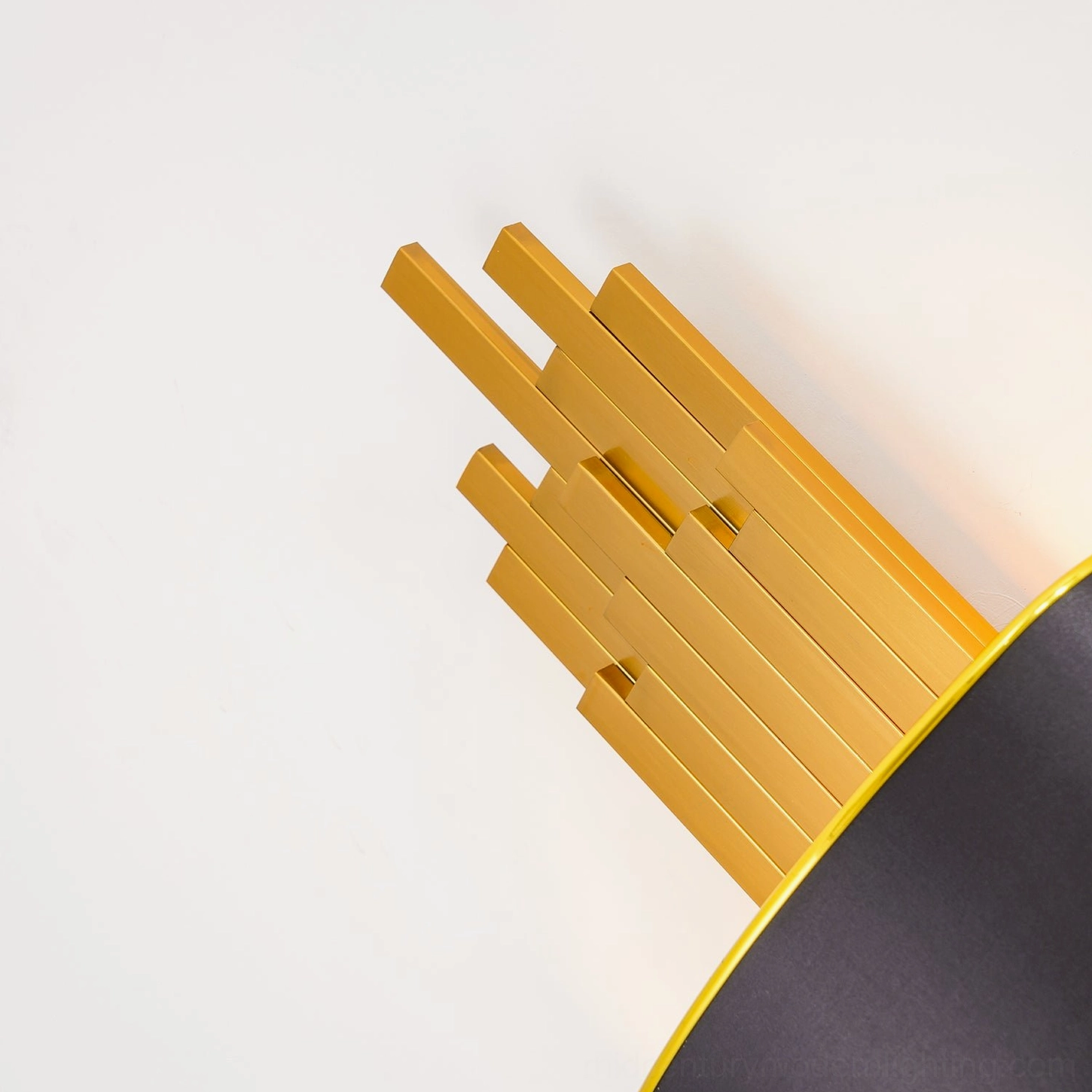Laurina wall lamp gold metal tube structure oblique view showing geometric architectural design