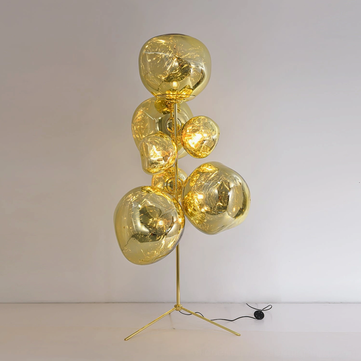 Lava cone floor lamp gold finish variant with contemporary tripod frame and artistic glass cones