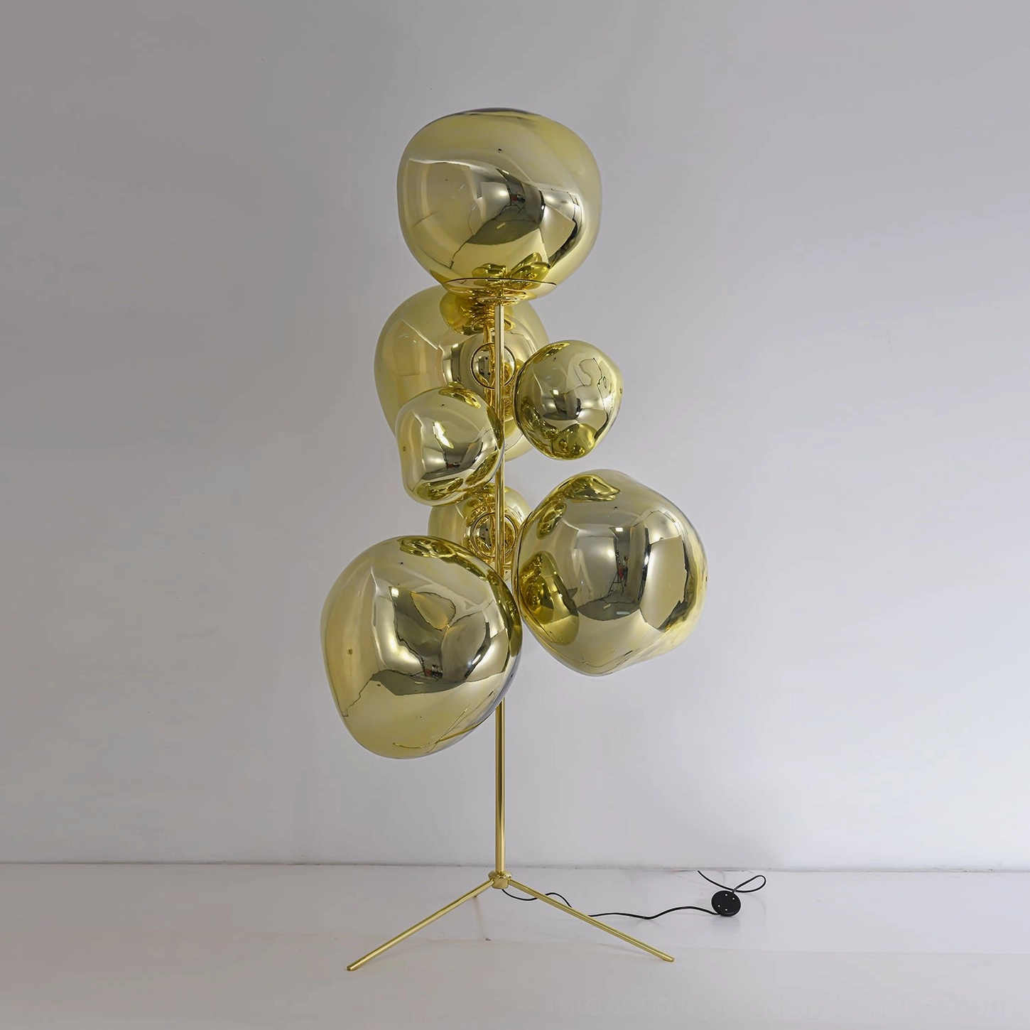 Gold finish lava cone floor lamp with warm metallic base and illuminated molten glass shades