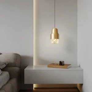 Gold brushed brass Lavinia pendant light hanging above side table in modern minimalist living room
