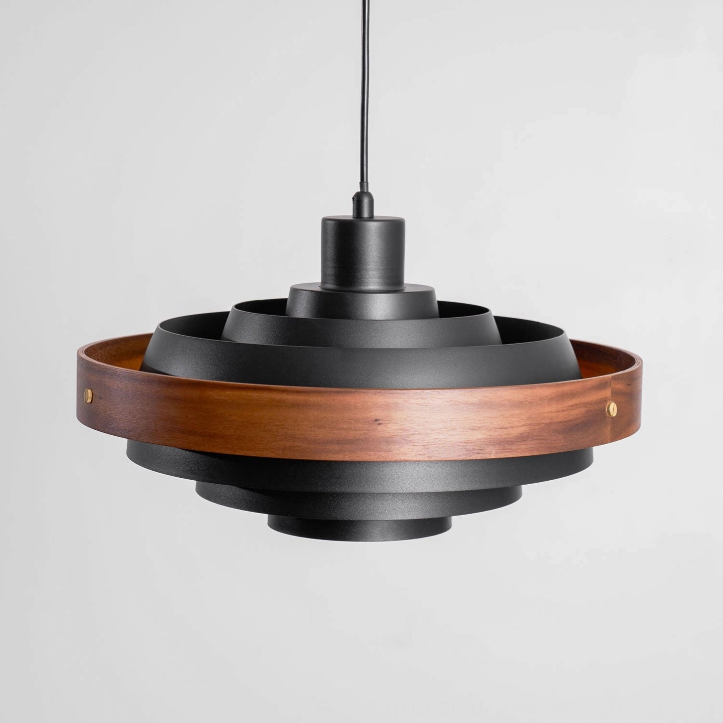 Layered pendant light shade showing alternating wood and metal tier construction texture