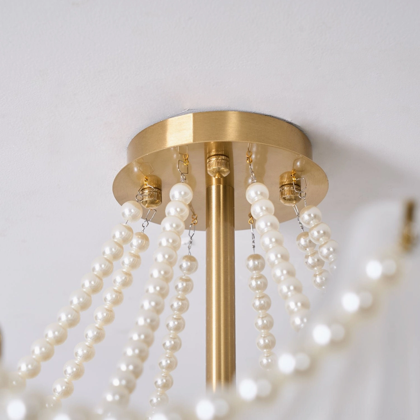 Layered scallop shell glass chandelier demonstrating multi-tier design with pearl accents and brass finish