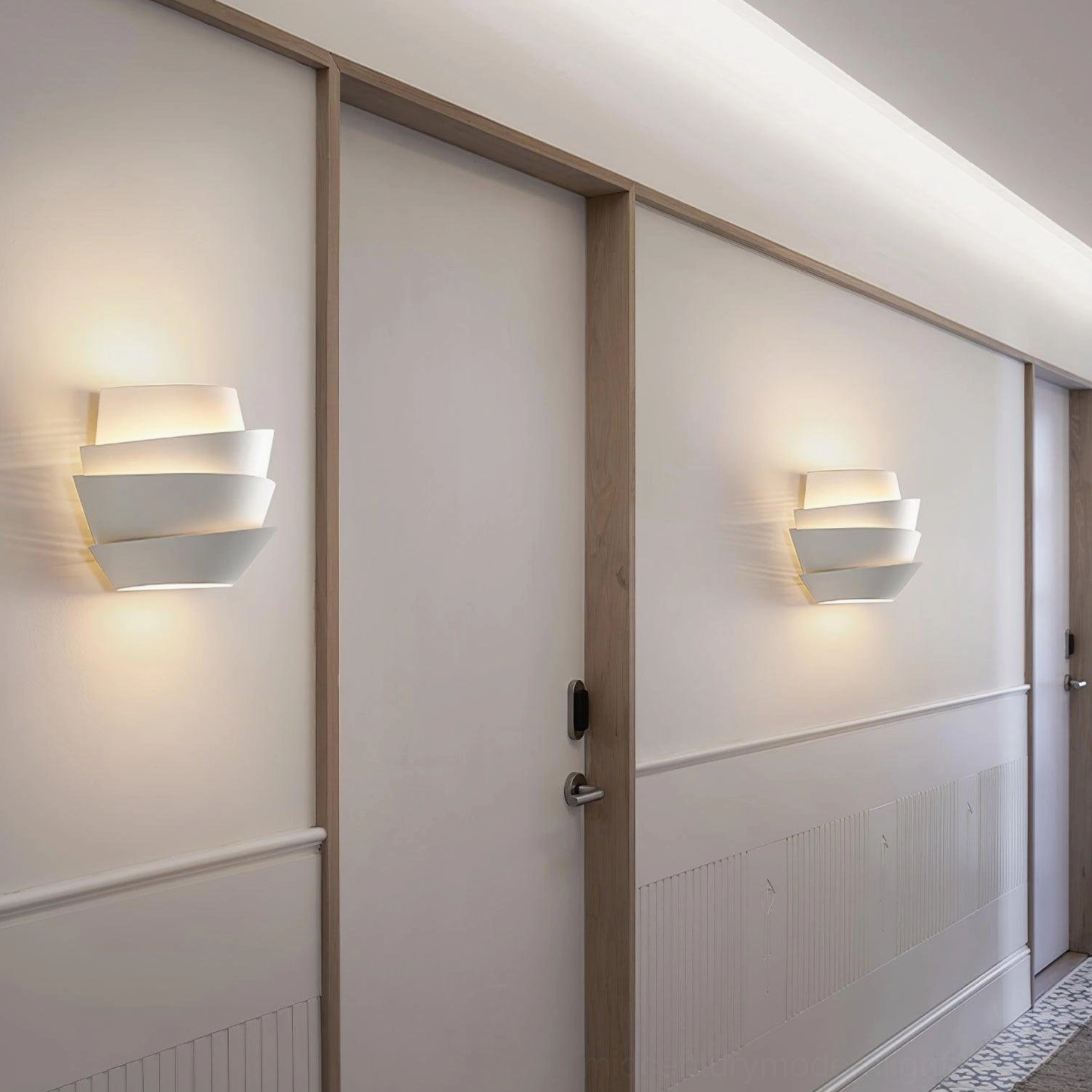 Le Soleil modern wall sconce installed in contemporary interior space showcase