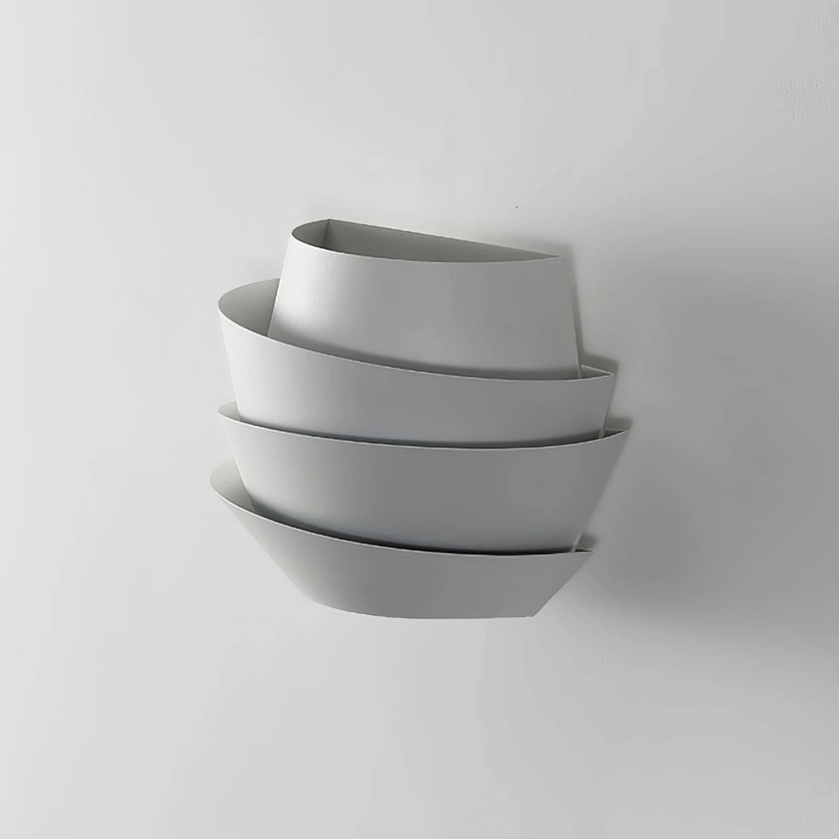Le Soleil contemporary wall sconce on white interior wall showing staggered layered bowl form
