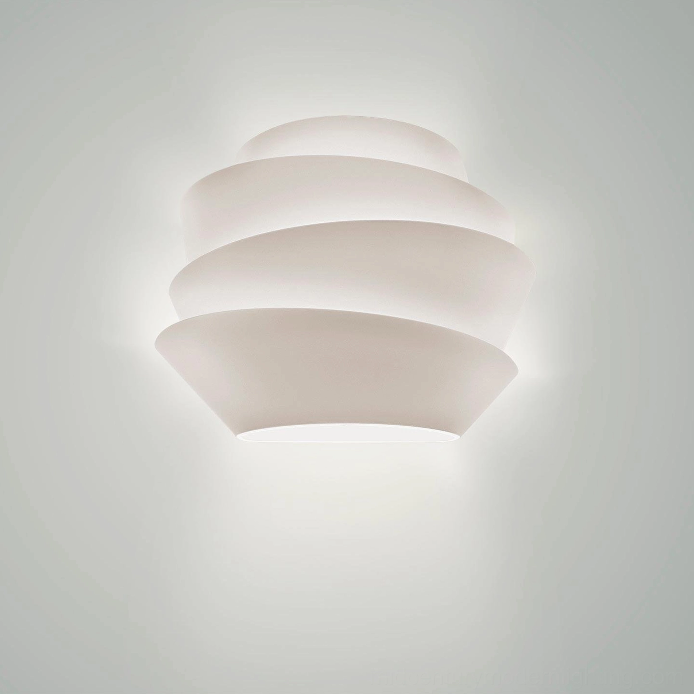 Front view of Le Soleil sculptural wall lamp with matte white rounded tiered structure