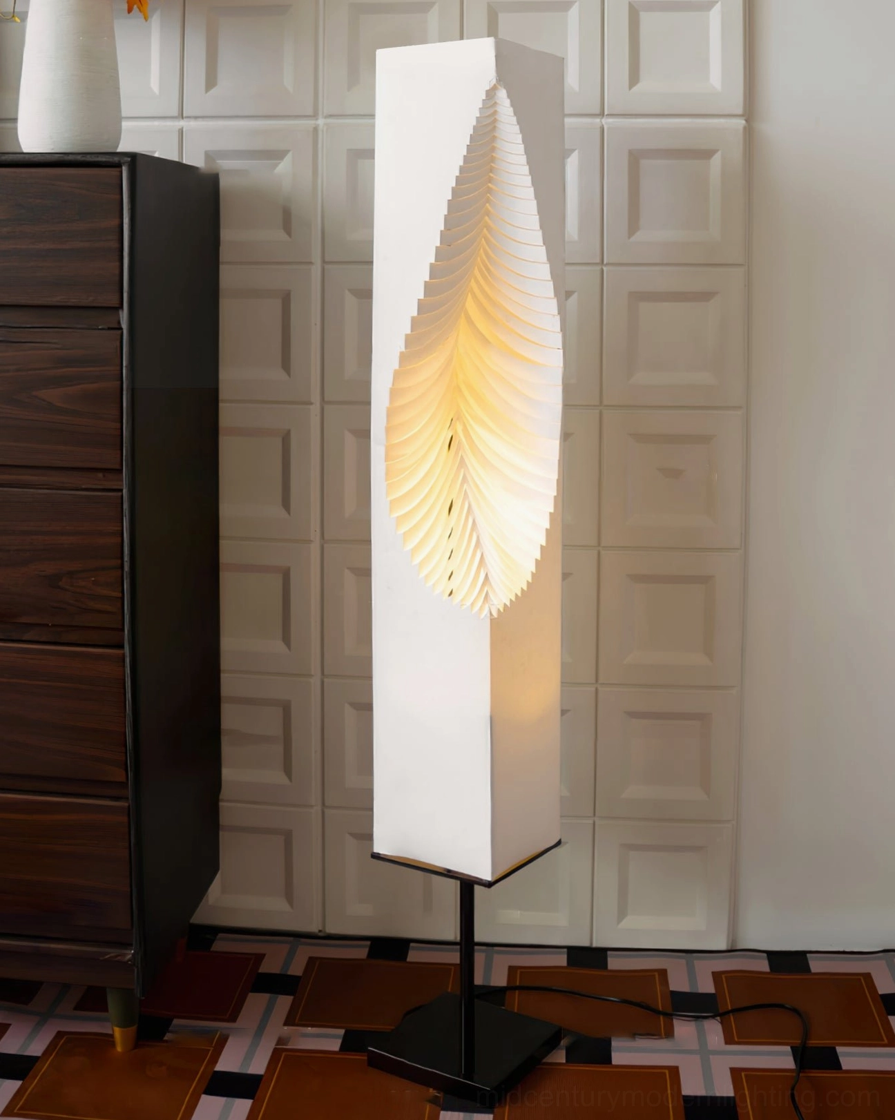 Leaf Floor Lamp side profile showing warm glowing leaf-shaped fabric shade over checkered floor setting