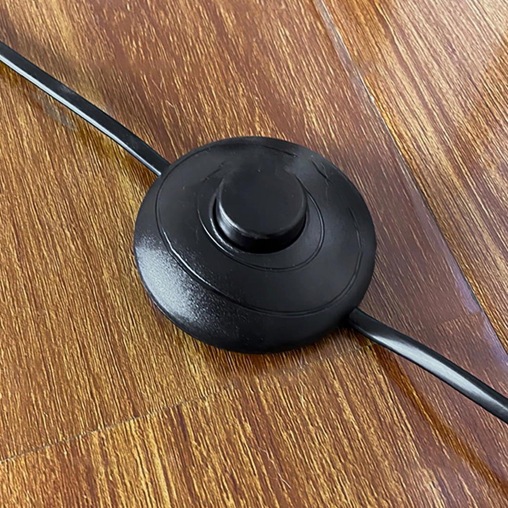 Leaf Floor Lamp foot switch and black power cord detail on wooden floor background