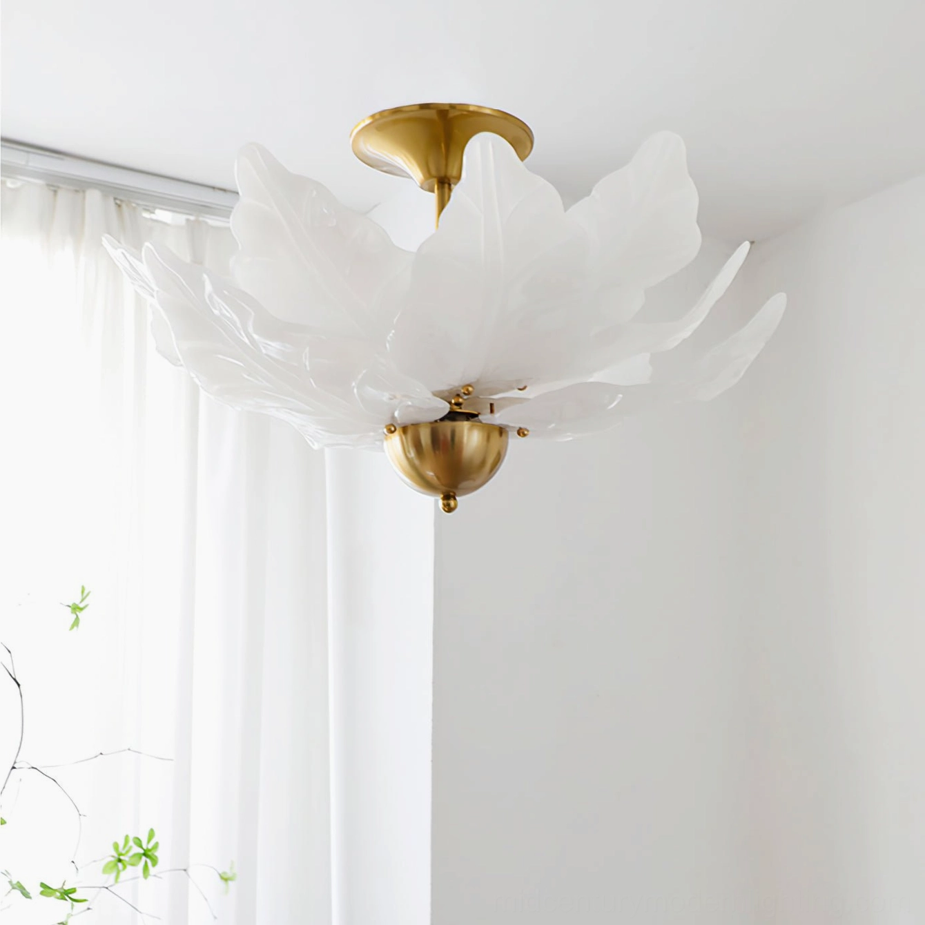 Leaf ceiling light installed in minimalist white bedroom with sheer curtain and green vines botanical styling