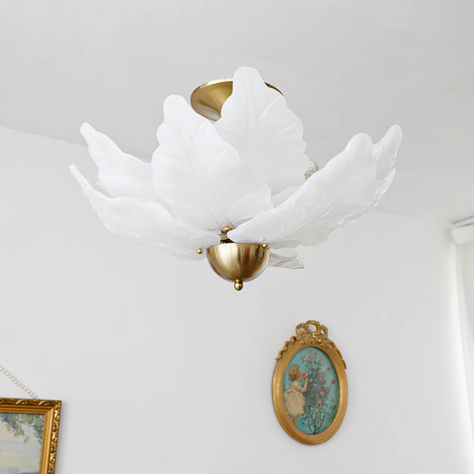 Leaf glass ceiling fixture side angle view in neoclassical white room with vintage oval framed wall art decor