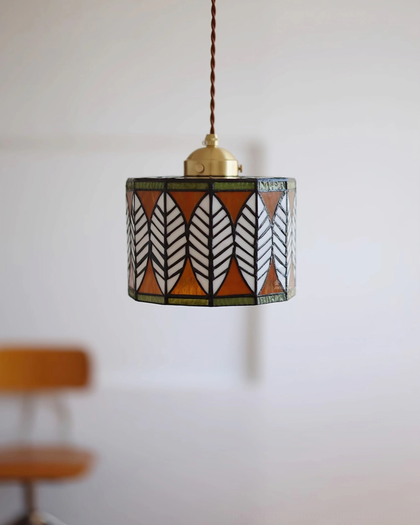 White stained glass leaf pattern Tiffany pendant with black-lined botanical design and brass top