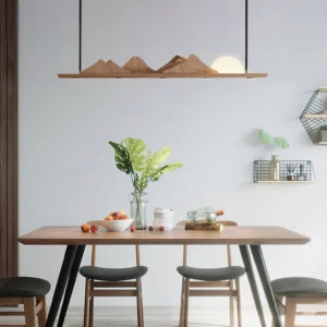 Leah Mountains mountain ridge dining pendant – installed above warm wood dining table with minimalist place settings and natural light