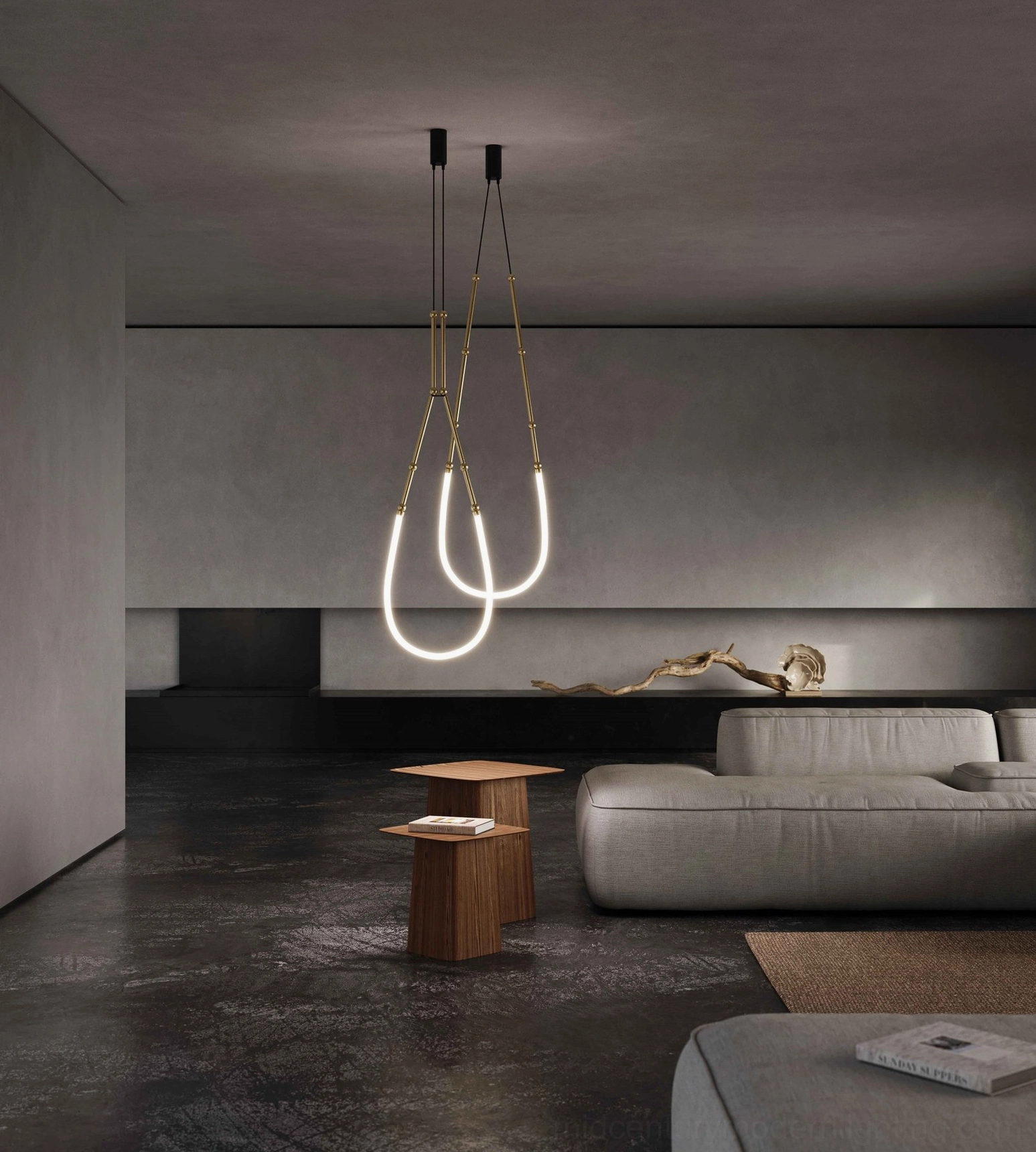 Dual-loop Leda sculptural chandelier in warm brass and black minimalist design, modern lounge lighting