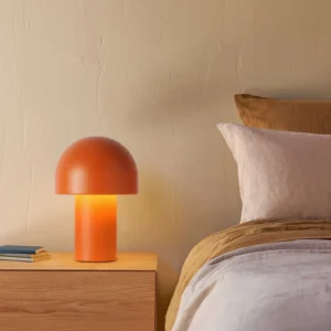Warm terracotta mushroom table lamp on bedroom nightstand with Nordic minimalist decor