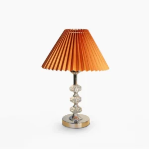 Lenny pleated table lamp with orange fabric shade and polished chrome metal base, front view studio photography