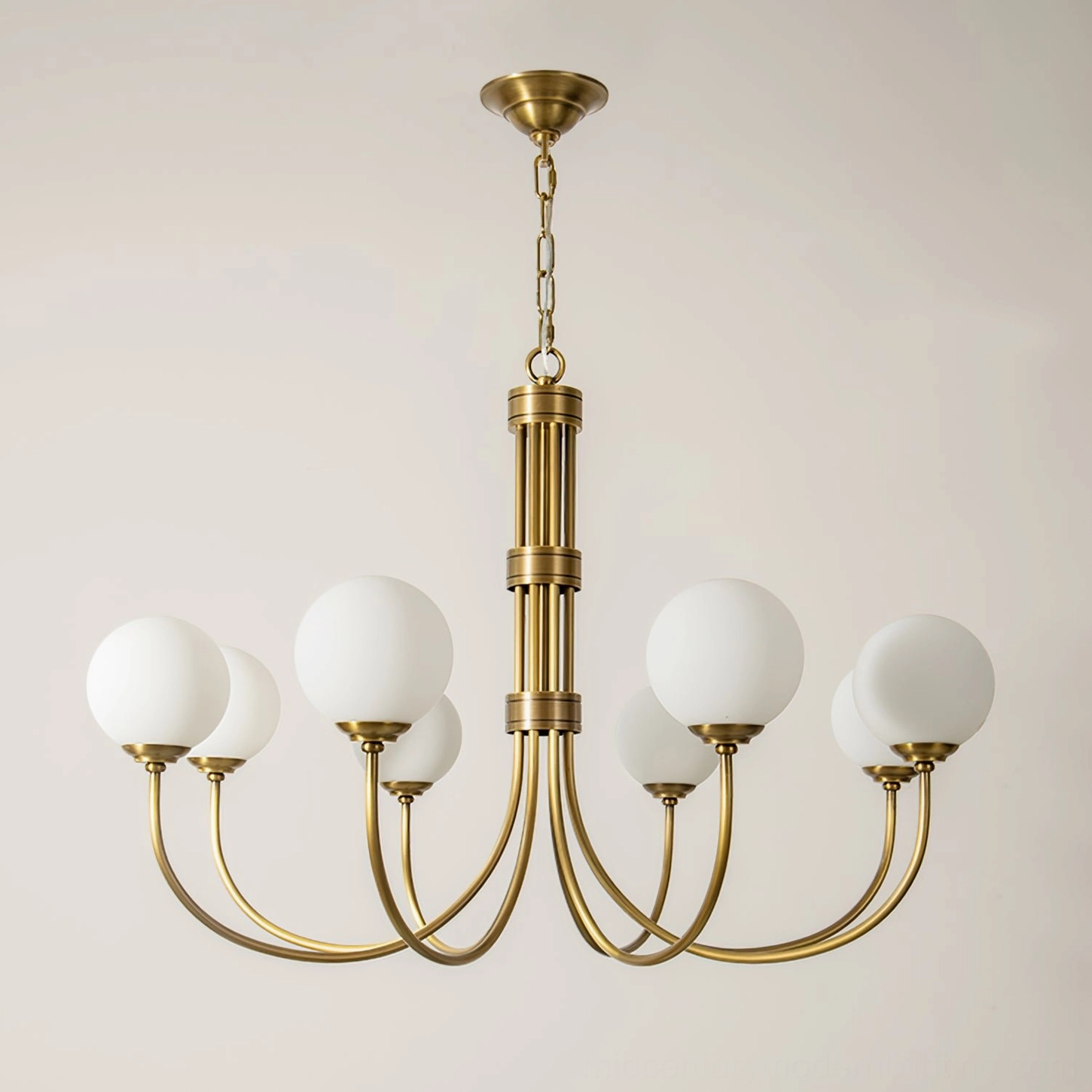 Eight-light brass chandelier with symmetrical curved arms and frosted glass globes, studio overhead view on neutral background