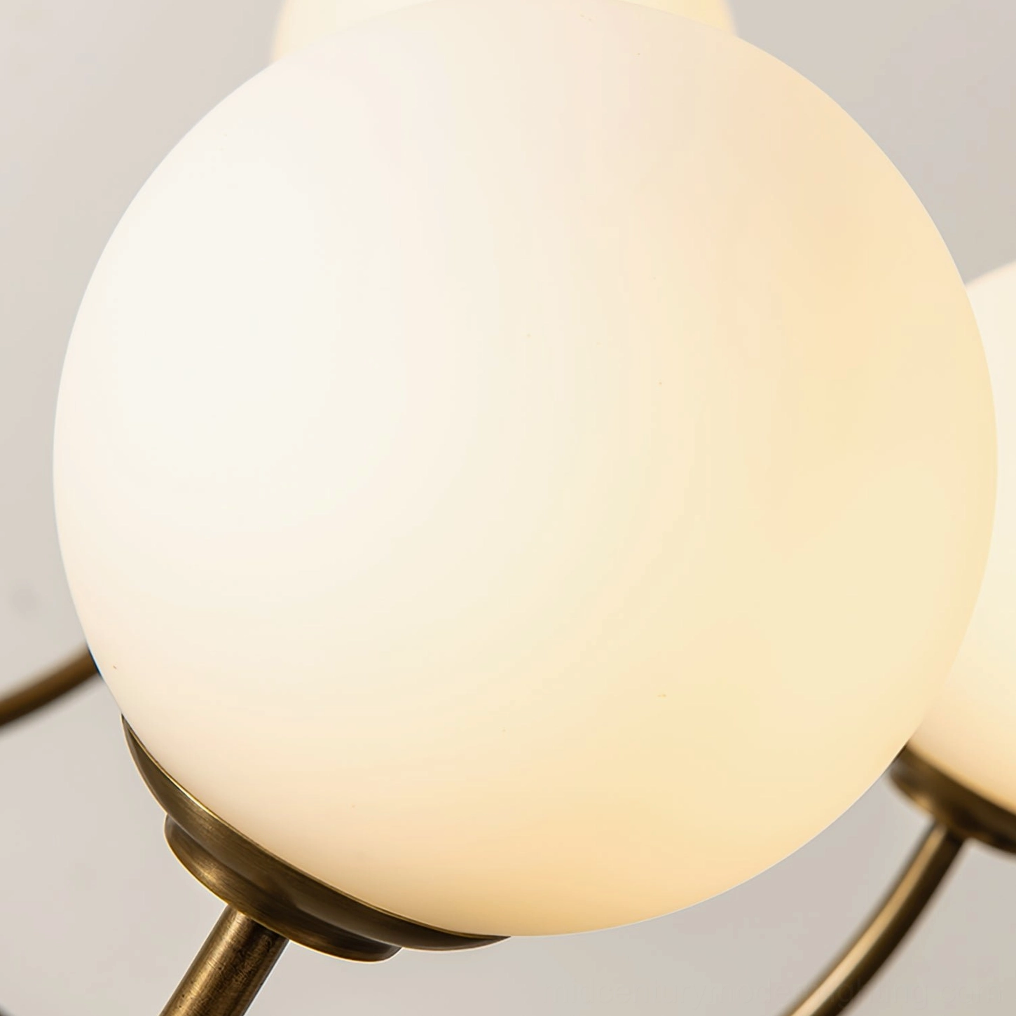 Frosted opal glass globe lamp shade close-up with warm glowing light inside, macro photography of chandelier shade