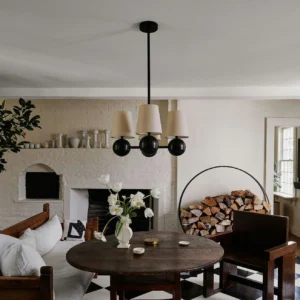 Leoda 4-light chandelier suspended over dining table in rustic farmhouse interior, warm ambient lighting