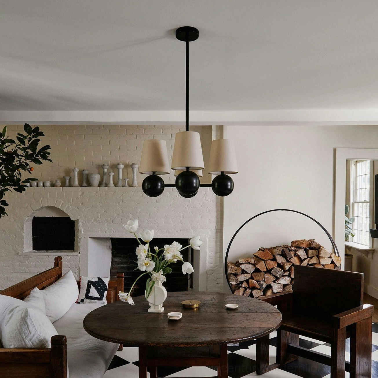 Leoda 4-light chandelier suspended over dining table in rustic farmhouse interior, warm ambient lighting