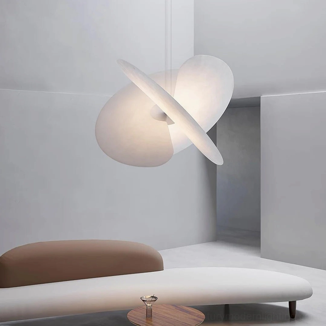 Modern hanging pendant light in wabi-sabi lounge area, neutral warm white curved disc shape above daybed