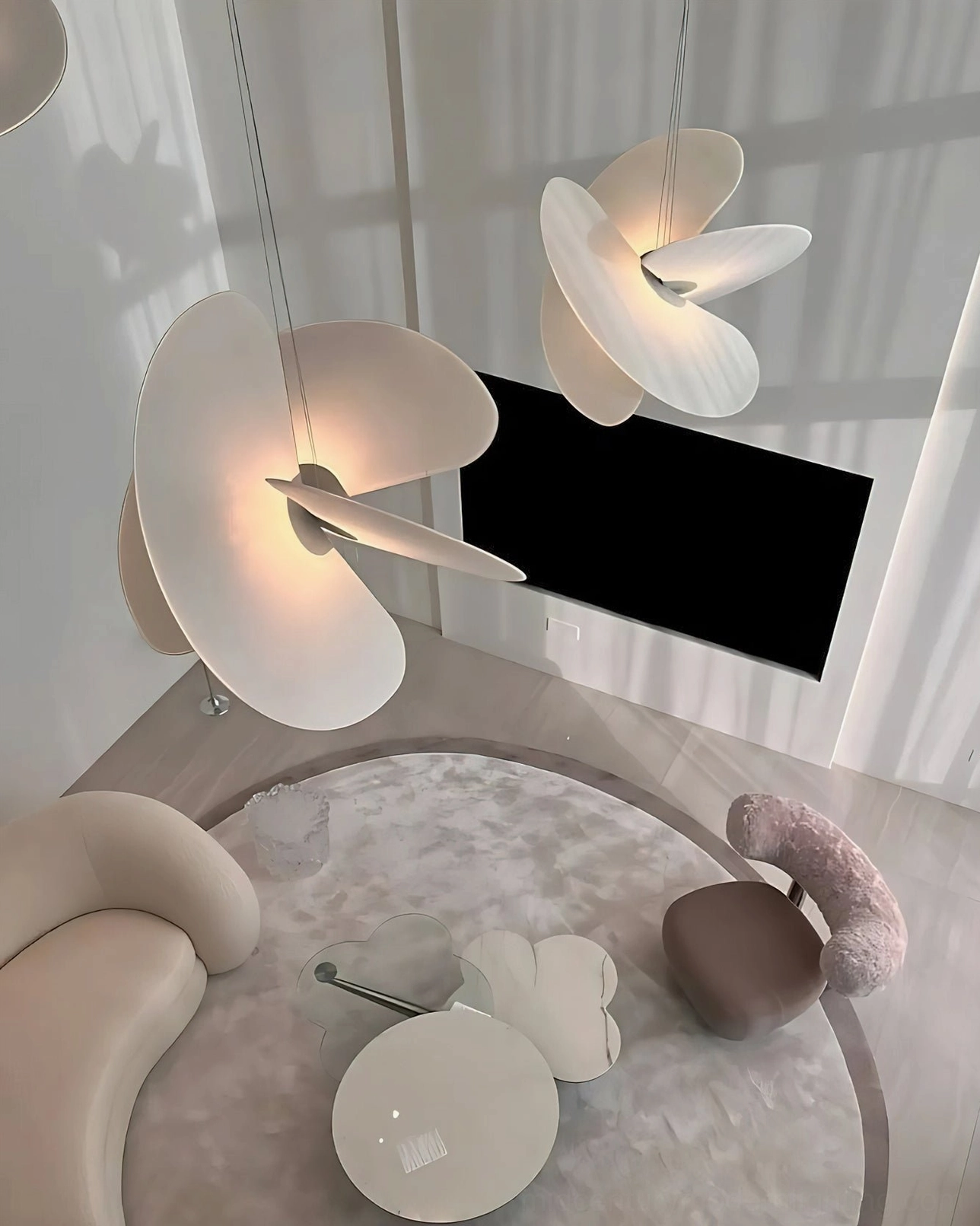 Multiple sized Levante pendant lamps in luxury minimalist living room, organic modern varying disc shapes warm white tone