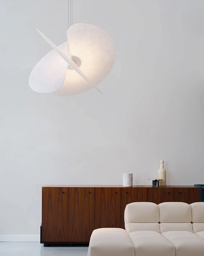 Sculptural pendant lighting fixture in minimalist living room, floating twisted disc with matte fabric-like texture