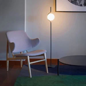 Black Levita floor lamp in modern minimalist living room with warm ambient lighting and Nordic interior design aesthetic