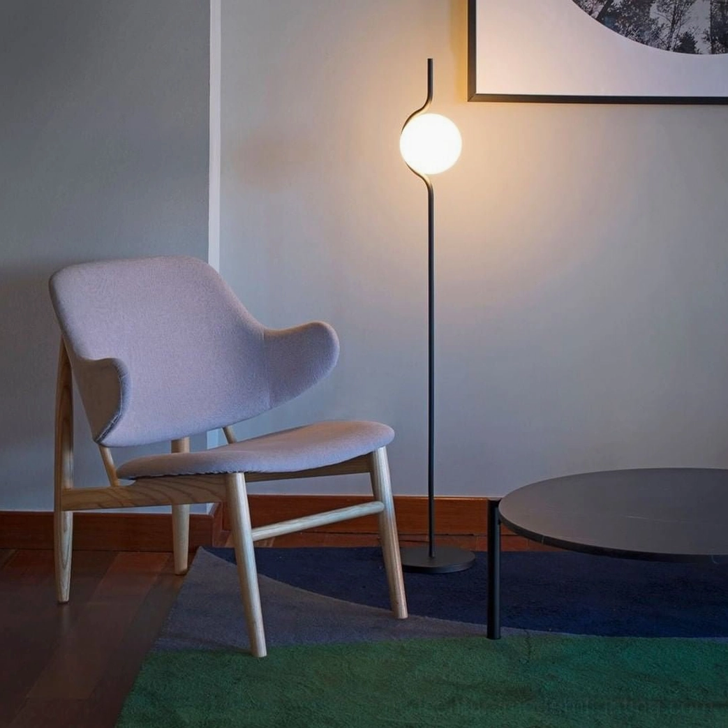 Black Levita floor lamp in modern minimalist living room with warm ambient lighting and Nordic interior design aesthetic