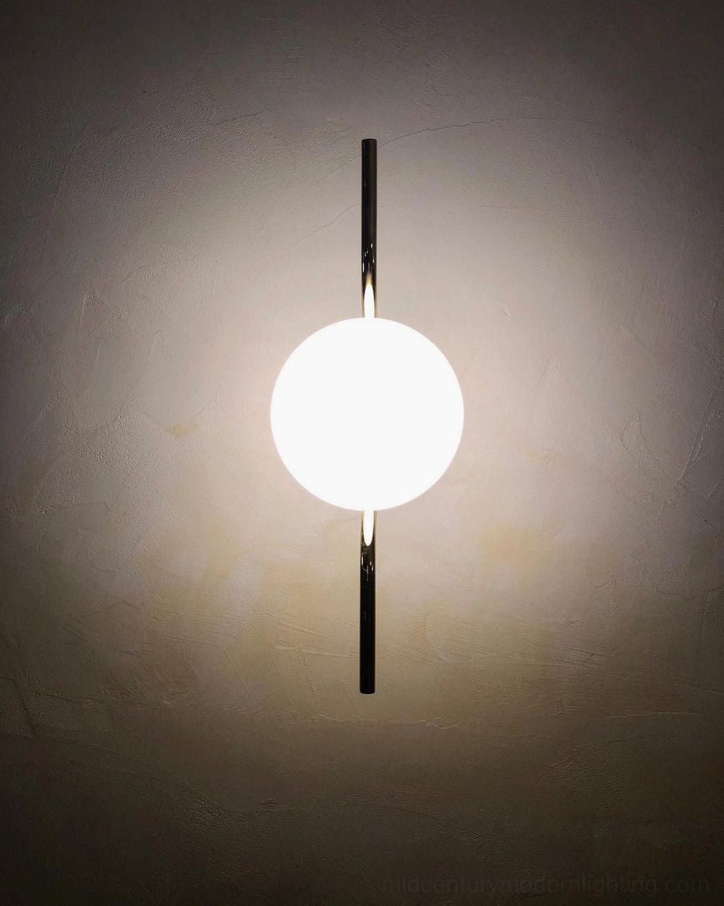 Levita linear black minimalist globe wall sconce close-up on textured accent wall, ultra-modern design detail