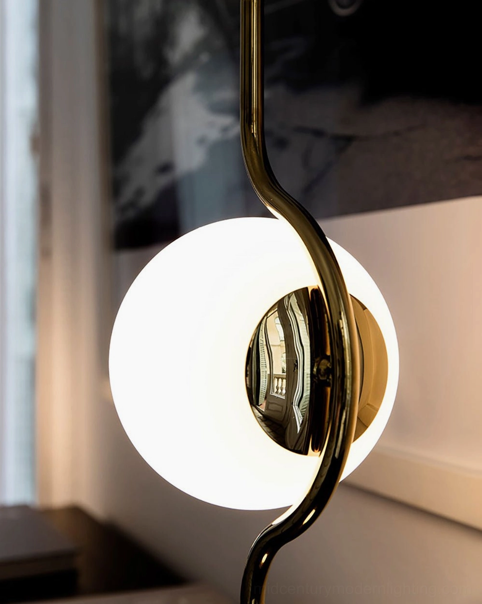 Macro close-up detail of Levita floor lamp fixture showing polished metal stem and internal lighting mechanism