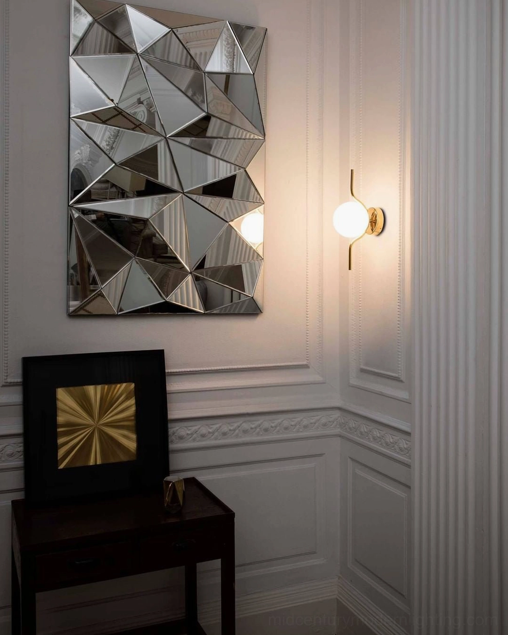 Compact Levita globe wall lamp in foyer entryway with geometric wall art and minimalist modern aesthetic