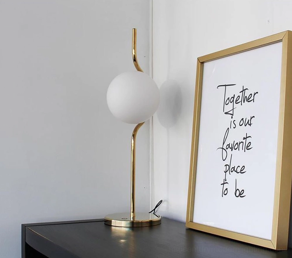 Levita mid-century modern table lamp on bedroom side table with minimalist decor and framed calligraphy art