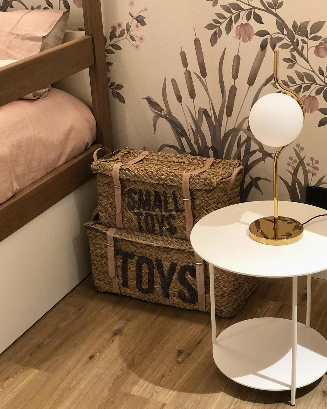 Levita mid-century modern table lamp in gold finish placed on white round side table in bedroom corner