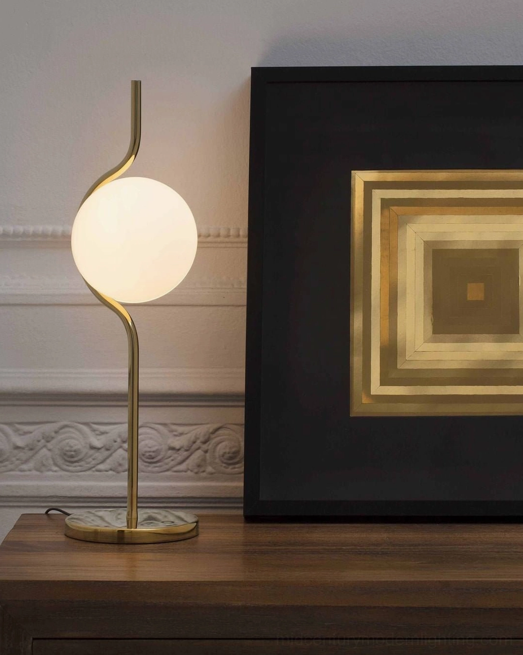Levita mid-century modern table lamp displaying polished metal finish and spherical glass lampshade from side angle