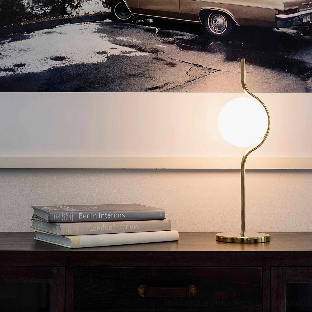 Levita table lamp glowing warm light on wooden console table with stacked books and modern home decor