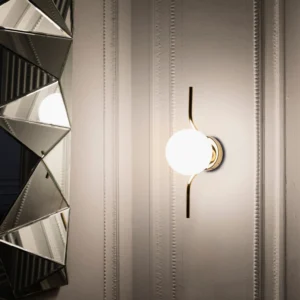 Levita contemporary wall lamp installed in luxury modern interior with paneled wall backdrop and neoclassical design elements