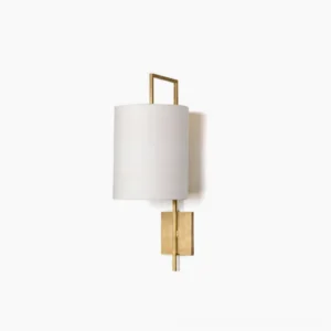 Lewes brass wall sconce with white fabric drum shade, frontal studio view