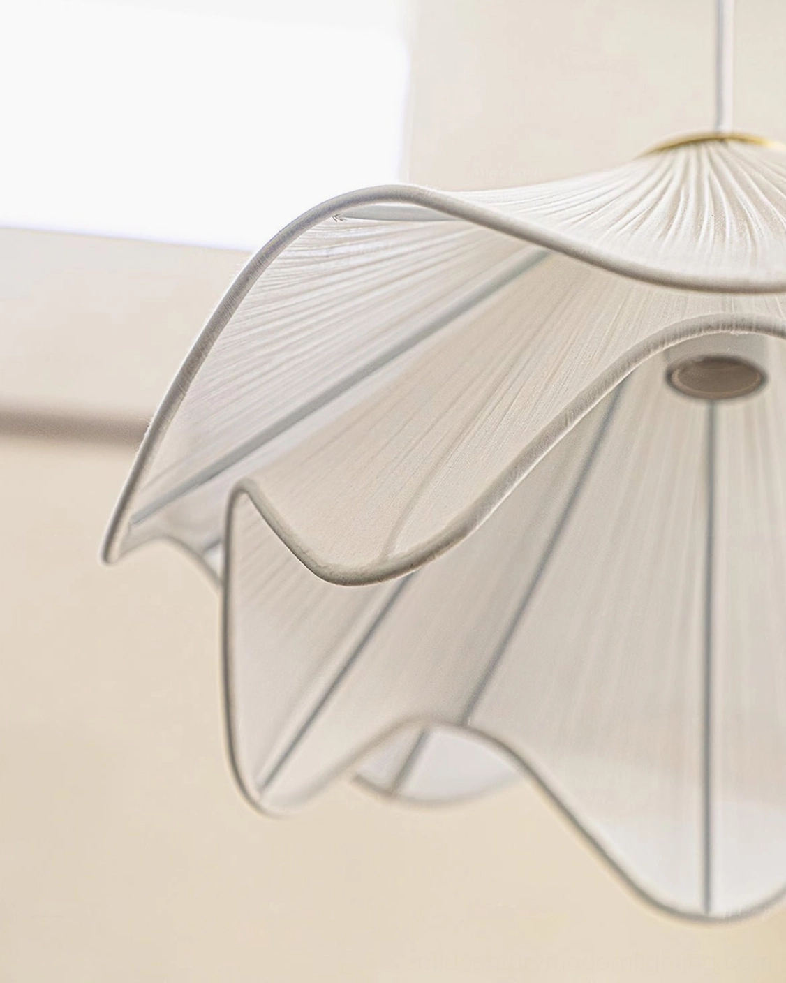 Side underside angle of Lia pendant lamp showing wavy pleated design layers, light socket, and quality hardware construction