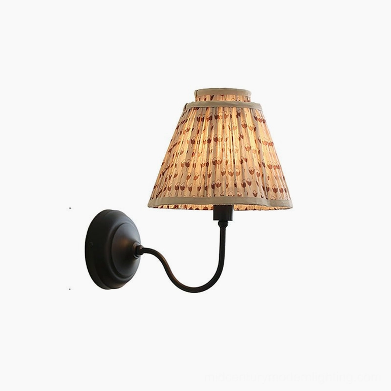 Light brown and black elbow wall sconce with pleated fabric shade, complete fixture view