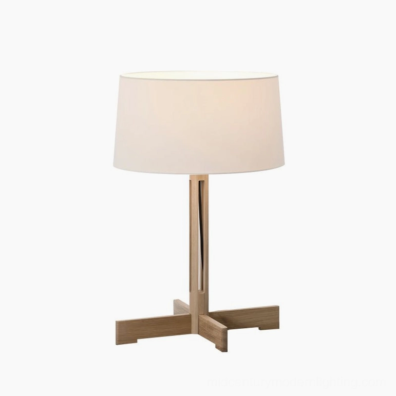 Light wood sculptural table lamp with cross base, minimalist front studio view